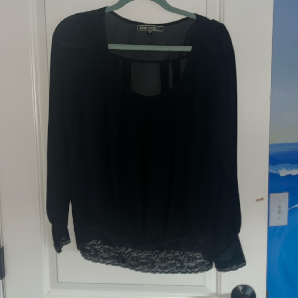 Black sheer blouse with lace sleeves and waistband.